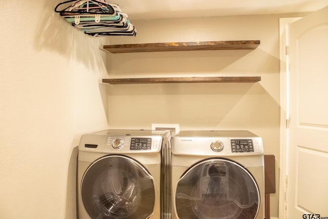 laundry room with laundry area and washing machine and clothes dryer