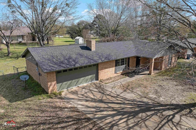 197 Sherman St, Rusk, TX 75785 - single story home with a garage, brick siding, a chimney, a shingled roof, and driveway