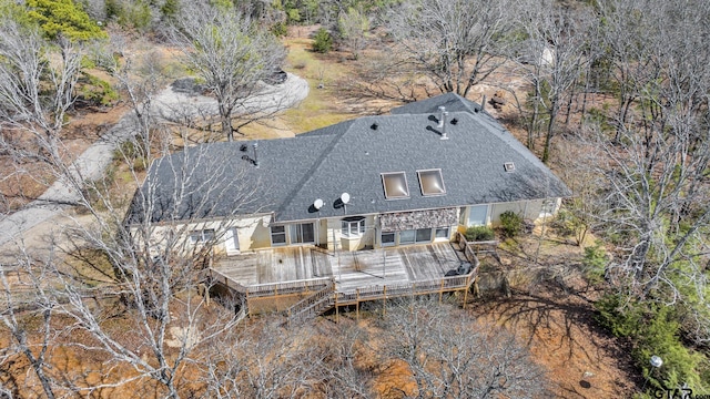 back of house featuring roof with shingles, stairs, and a wooden deck