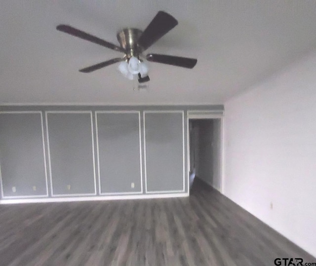 unfurnished bedroom with ceiling fan and dark hardwood / wood-style floors