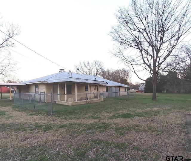 rear view of property featuring a yard