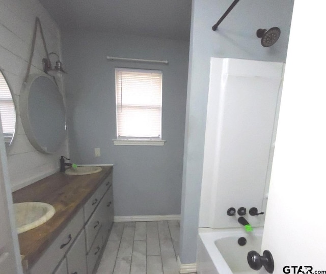 bathroom featuring vanity and tub / shower combination