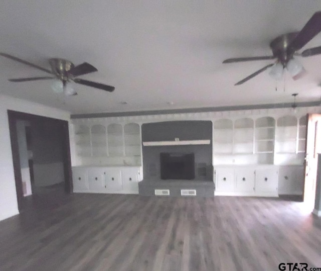 unfurnished living room featuring hardwood / wood-style flooring and ceiling fan