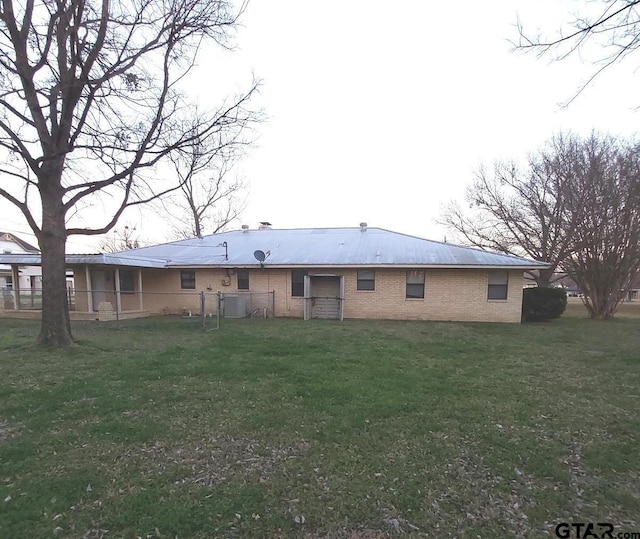 rear view of property featuring a yard