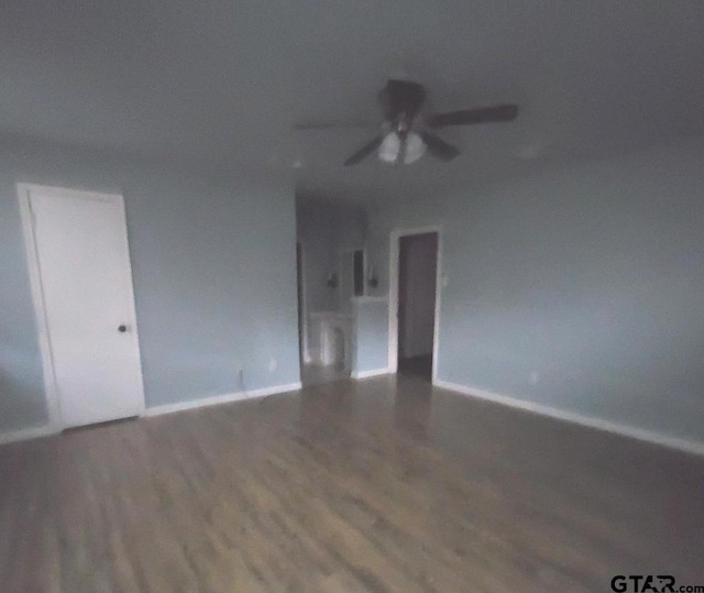 empty room with hardwood / wood-style floors and ceiling fan