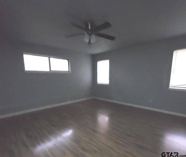 spare room with wood-type flooring and ceiling fan