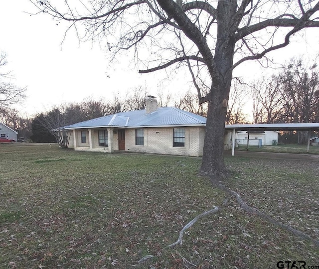 ranch-style house with a carport and a front yard