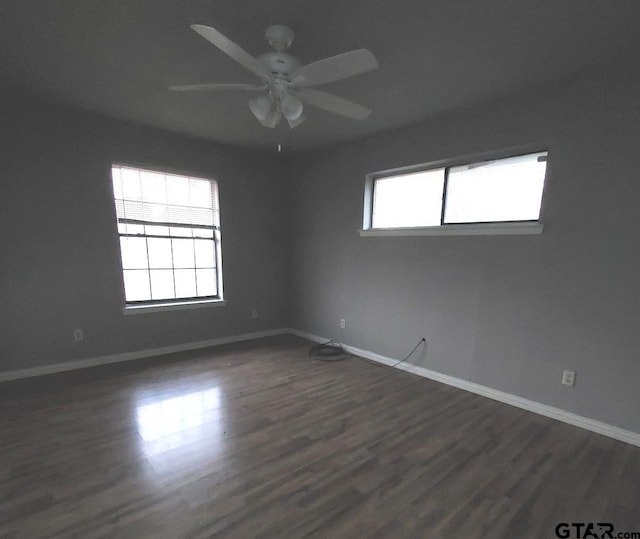 unfurnished room featuring ceiling fan and dark hardwood / wood-style floors