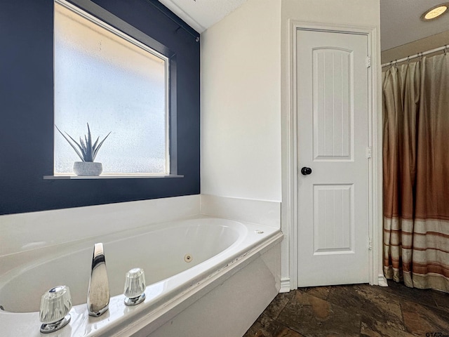 619 Winchester Dr, Chandler, TX 75758 - bathroom with stone finish flooring and a tub with jets