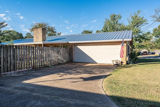 garage featuring driveway and fence