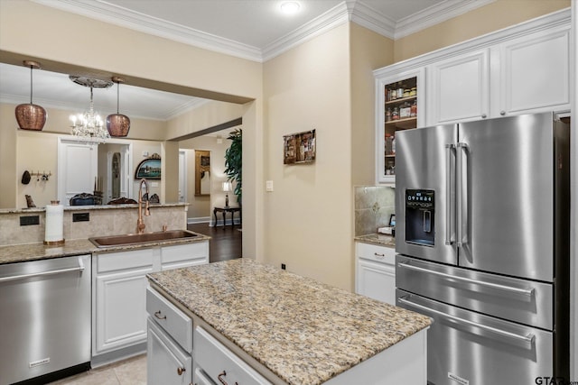 3351 Cascades Ct, Tyler, TX 75709 - kitchen with light stone counters, glass insert cabinets, stainless steel appliances, and a sink