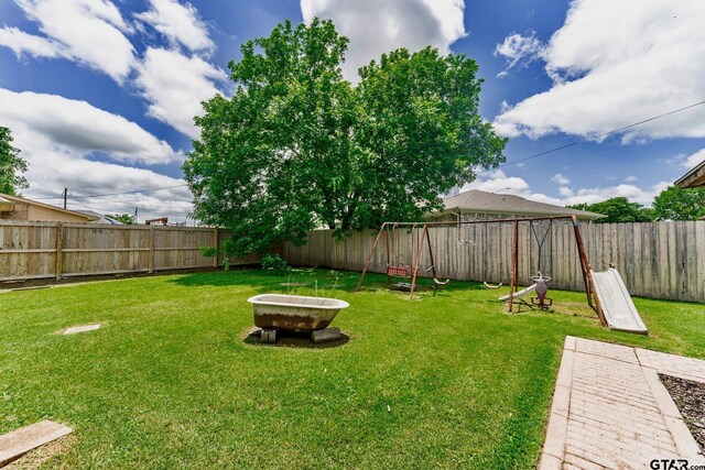 1881 Woodbridge Dr, Sulphur Springs, TX 75482 - view of yard with a playground and a fire pit