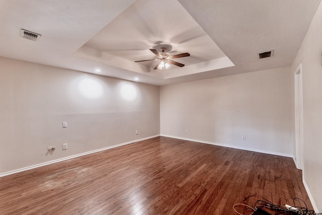 1881 Woodbridge Dr, Sulphur Springs, TX 75482 - empty room featuring a ceiling fan, a tray ceiling, baseboards, and wood finished floors