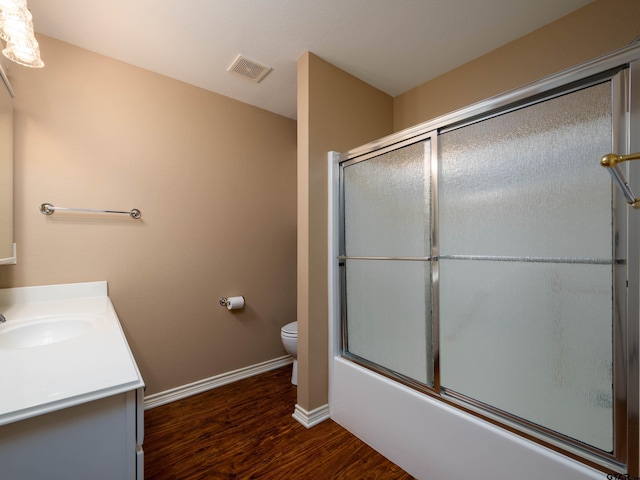 1521 Rice Rd Unit U102, Tyler, TX 75703 - full bathroom featuring wood finished floors, vanity, and bath / shower combo with glass door