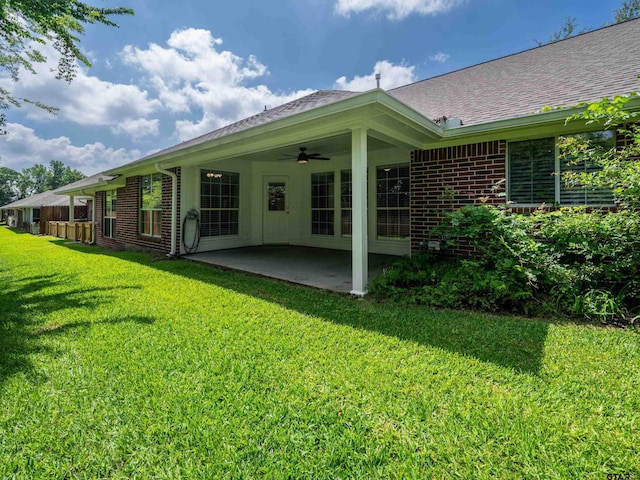 1521 Rice Rd Unit U102, Tyler, TX 75703 - rear view of house with a patio, a ceiling fan, brick siding, and a lawn