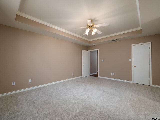 1521 Rice Rd Unit U102, Tyler, TX 75703 - spare room with a raised ceiling, ornamental molding, a ceiling fan, and carpet floors
