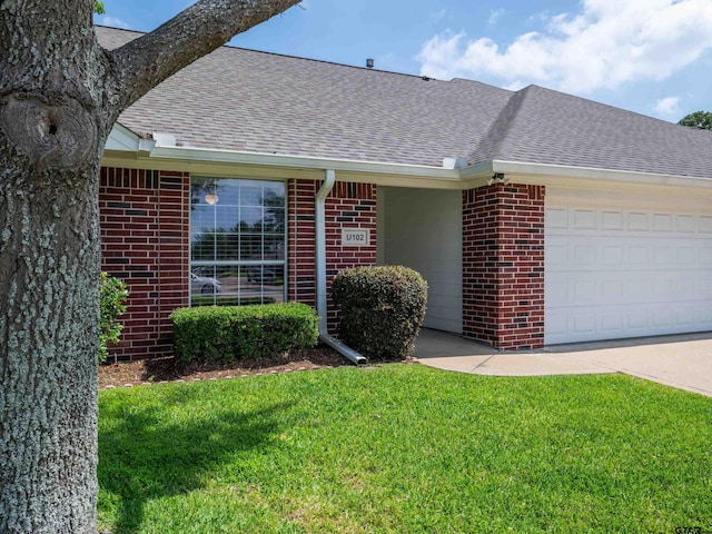 1521 Rice Rd Unit U102, Tyler, TX 75703 - ranch-style house featuring brick siding, a shingled roof, a front yard, and a garage