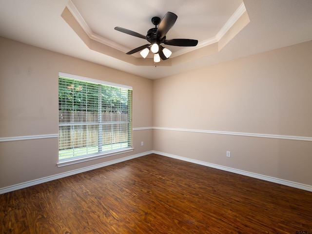 1521 Rice Rd Unit U102, Tyler, TX 75703 - empty room featuring a raised ceiling, ornamental molding, dark wood-style floors, and ceiling fan