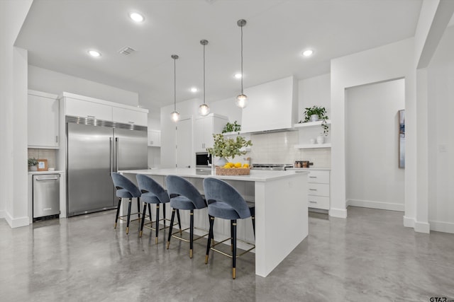 kitchen featuring pendant lighting, white cabinetry, stainless steel built in fridge, and custom range hood