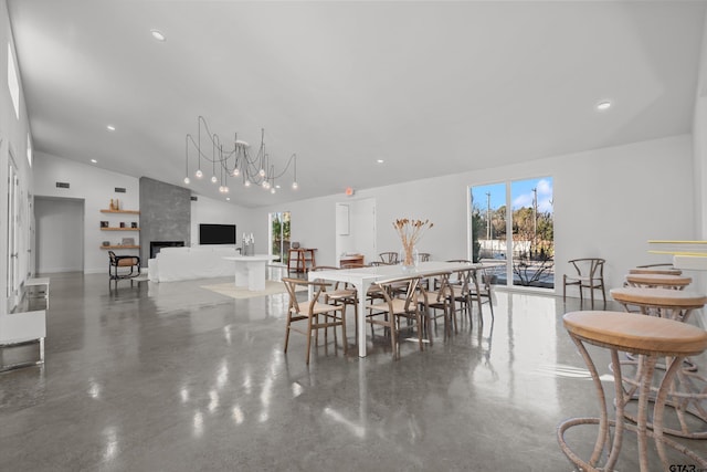 dining space featuring a premium fireplace and lofted ceiling