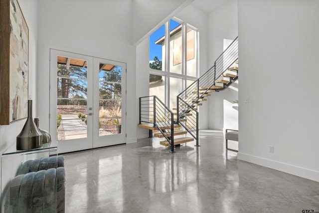 foyer with french doors and a high ceiling