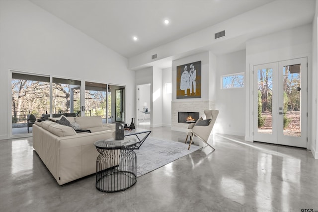 living room featuring french doors, plenty of natural light, and a high ceiling