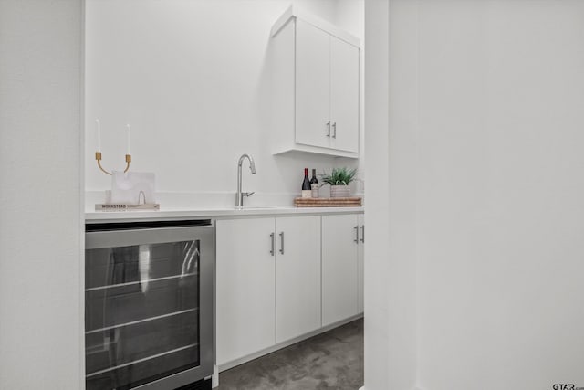 bar featuring white cabinetry, wine cooler, and sink