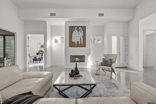 living room featuring french doors and a healthy amount of sunlight