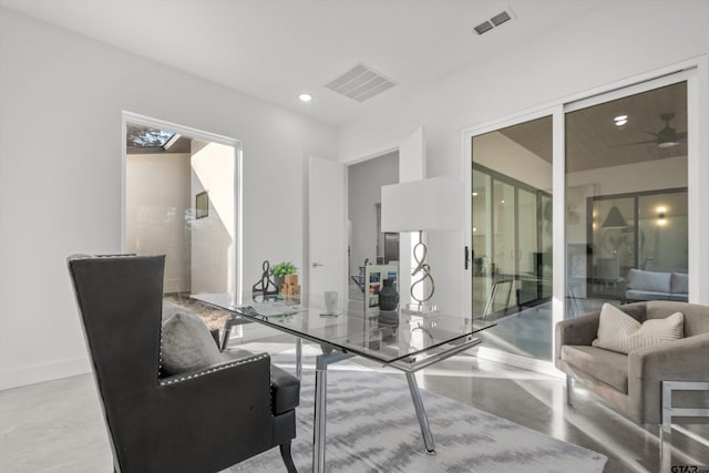 interior space with concrete floors and ceiling fan