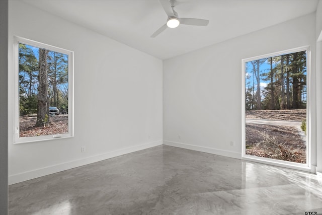 spare room with ceiling fan and concrete flooring