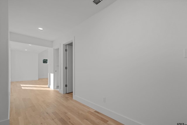 corridor with light hardwood / wood-style flooring