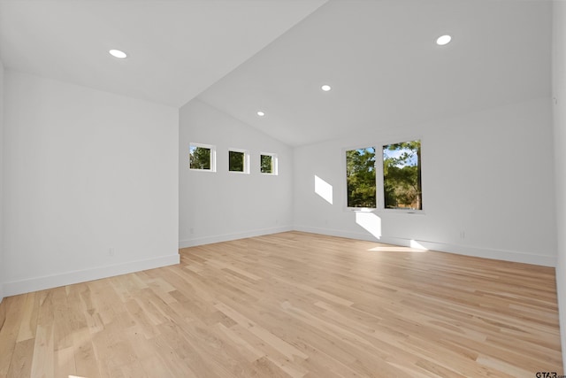 unfurnished room with light hardwood / wood-style floors and vaulted ceiling