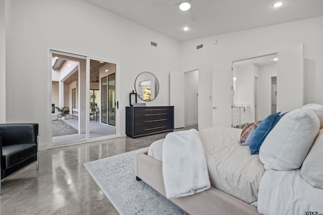 bedroom featuring access to exterior, ceiling fan, ensuite bathroom, a towering ceiling, and concrete flooring