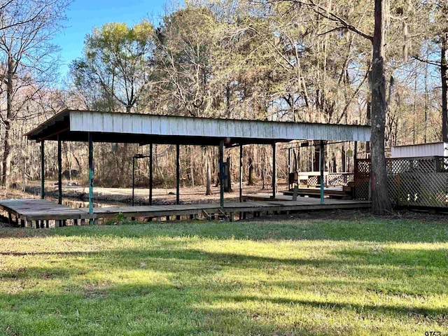 view of community with a wooden deck and a yard