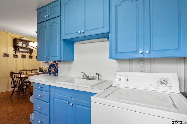 washroom with washer / clothes dryer, cabinets, and sink