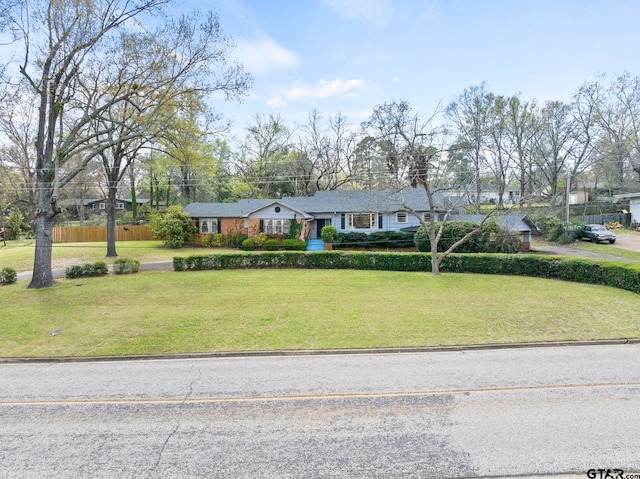 ranch-style home with a front lawn