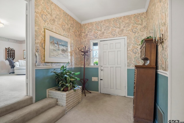 carpeted entrance foyer with crown molding