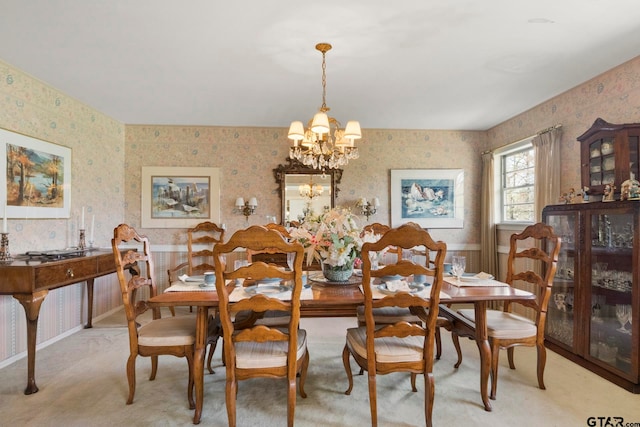 dining room featuring light carpet and a notable chandelier