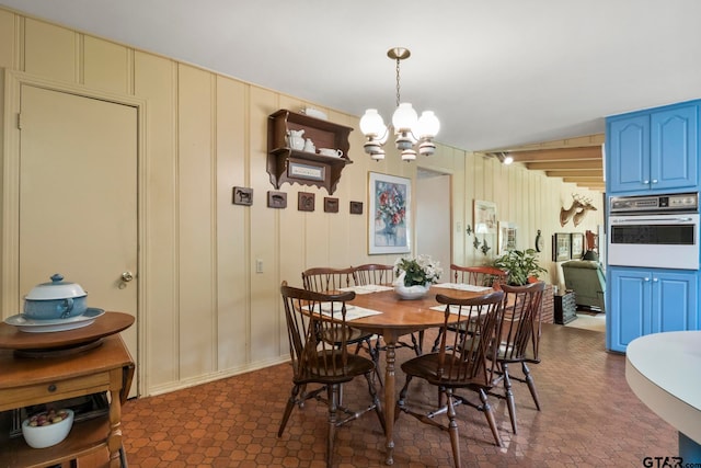 dining area with an inviting chandelier