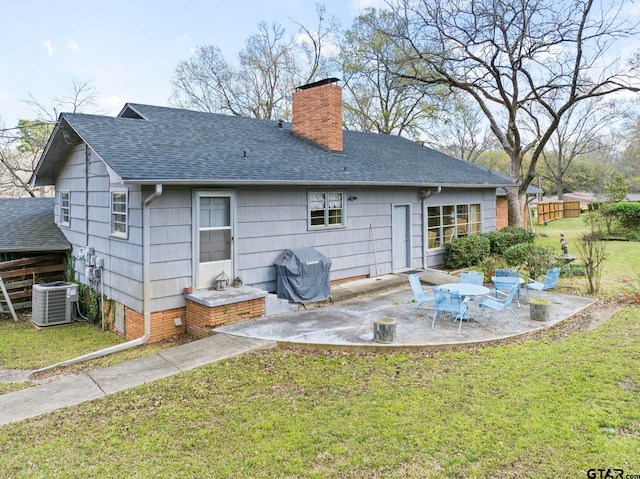 rear view of house with a yard, a patio, and cooling unit