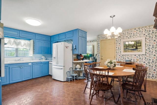 dining room featuring plenty of natural light, a chandelier, and sink