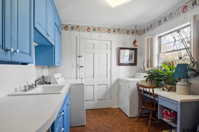 washroom with independent washer and dryer, cabinets, and sink