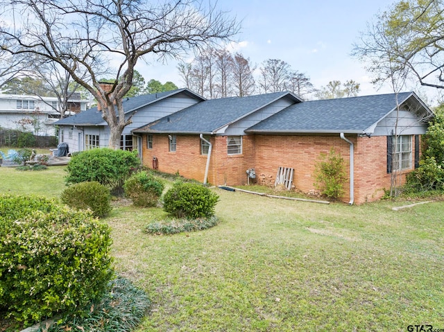 view of home's exterior with a yard