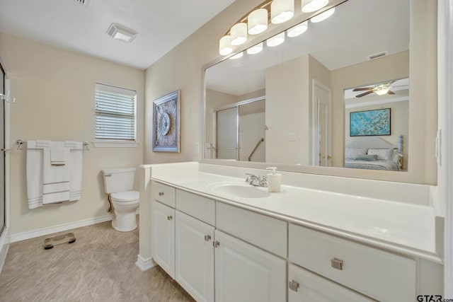 1521A101 Rice Rd, Tyler, TX 75703 - ensuite bathroom featuring a shower stall, baseboards, vanity, toilet, and ceiling fan