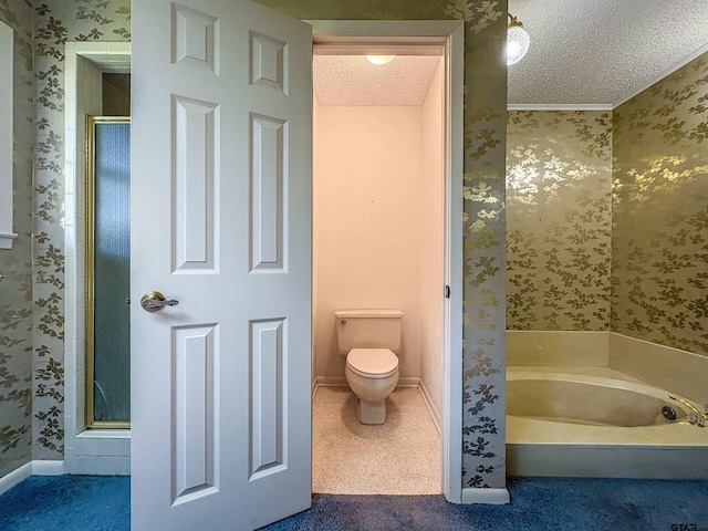 bathroom with a shower stall, a textured ceiling, wallpapered walls, a bath, and toilet