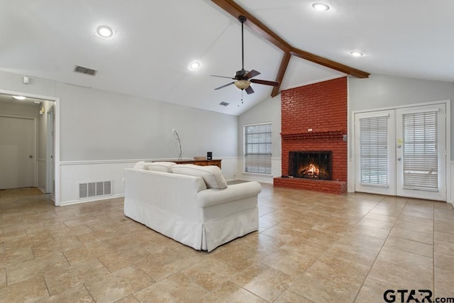 unfurnished living room with plenty of natural light, visible vents, and beamed ceiling