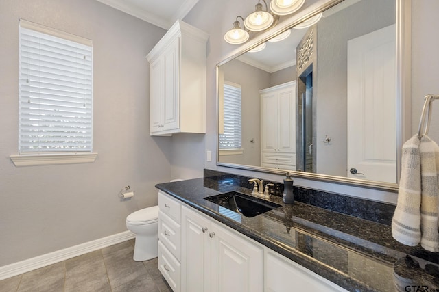 full bathroom featuring ornamental molding, toilet, vanity, and baseboards