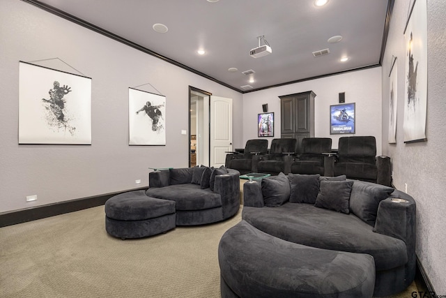 home theater room featuring baseboards, carpet, visible vents, and crown molding