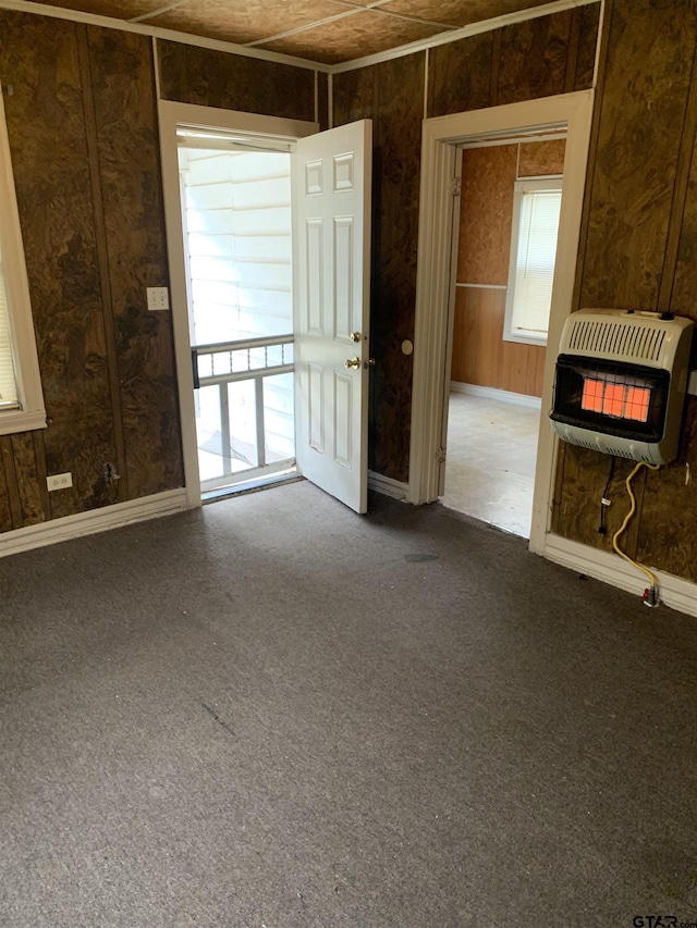 carpeted empty room with heating unit