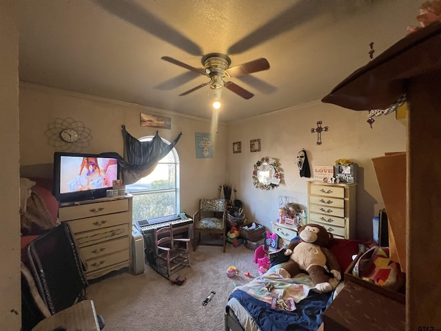 carpeted bedroom featuring ceiling fan and ornamental molding